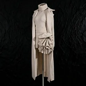 Detail of beige three-piece knit set featuring long cardigan and 3D floral mini skirt