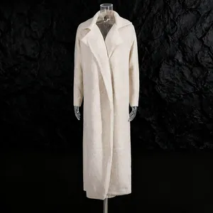 Close-up of elegant long textured coat in off-white finish against dark background