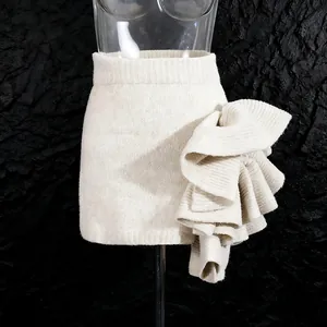 Detailed view of cream knitted mini skirt with dramatic 3D side ruffle texture