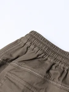 Close-up macro detail showing high waist elasticated waistband on khaki women's midi skirt