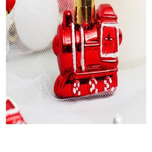 Detailed close-up of a red metallic train Christmas ornament with white glitter accents.