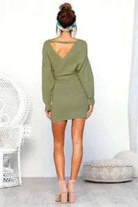 Back view of an olive green knit bodycon dress with V-neck and lace-up waist detail.