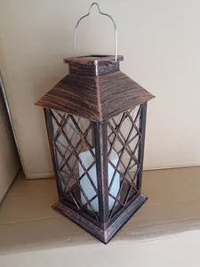 Authentic vintage bronze solar lantern with flickering candle for outdoor garden decor