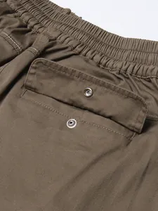 Detailed view of elastic waistband and snap pocket on a high-waist cargo skirt