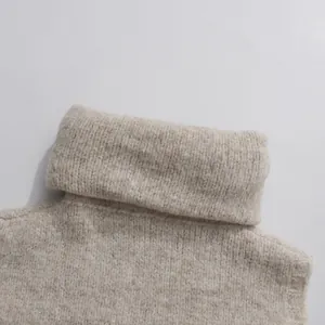 Detailed macro view of beige knitted turtleneck sweater collar and soft wool texture