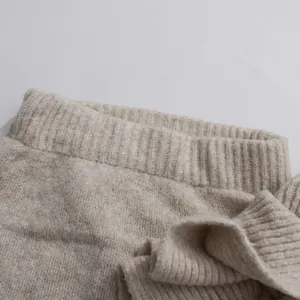 Detail shot of soft oatmeal knitted skirt featuring a comfortable ribbed waistband