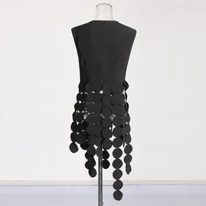 Detailed back view of black sleeveless top with laser-cut circular disc fringe