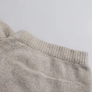 Close-up detail of the elastic ribbed waistband on a high-quality beige knitted skirt