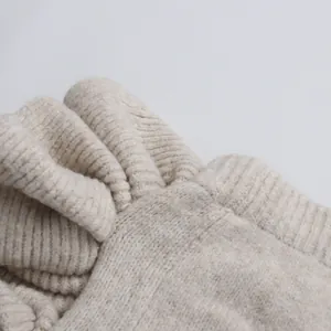 Close-up detail of soft oatmeal knitted fabric texture for a stylish skirt and sweater set