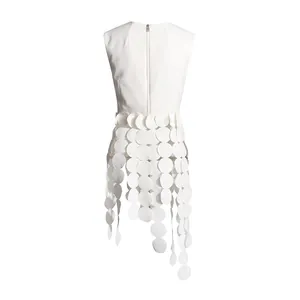 Detail view of white sleeveless top featuring back zipper and unique circular disk fringe
