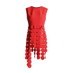 Close-up of vibrant red sleeveless top featuring unique circular sequin fringe details.