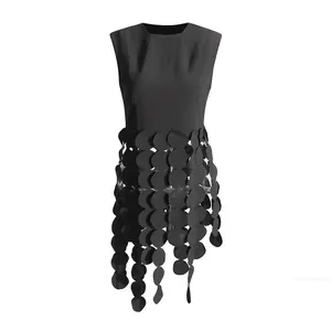 Close-up detail of stylish black sleeveless vest top featuring unique circular fringe design
