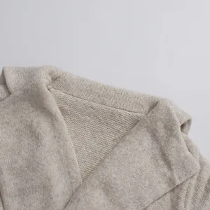Close-up detail of oatmeal knitted sweater texture and collar stitching craftsmanship