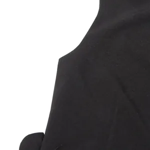 Macro close-up showing the shoulder seam and textured black fabric of a sleeveless vest top