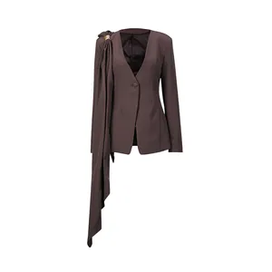 Detailed view of elegant dark plum blazer featuring a unique draped ribbon and deep V-neckline