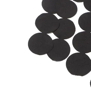 Macro detail view of black circular fabric patches for casual sleeveless top design