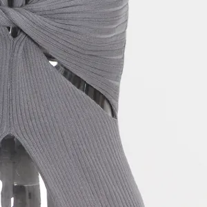 Detailed view of the twisted knot and hollow cut-out design on gray ribbed knit top