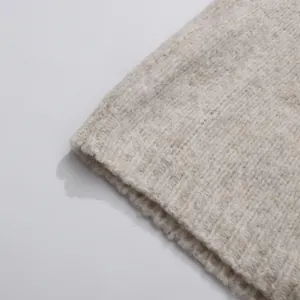 Macro detail view of oatmeal beige chunky ribbed knit fabric texture of a sweater