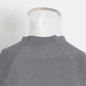 Close-up detail of the mock neck and rib-knit texture of the grey sleeveless top.