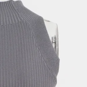 Close-up of grey ribbed knit sleeveless top featuring a mock neck and fine texture detail.
