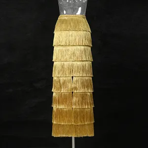 Detailed view of a golden tiered fringe long skirt featuring a stylish high waist design