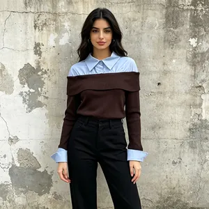 Detailed view of fake two-piece knit sweater with light blue shirt collar and cuffs.