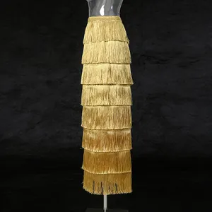 Detail view of the multi-tiered golden fringe high-waisted long skirt texture