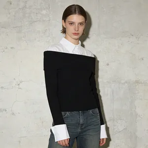 Detailed view of the contrast shirt collar and cuff splicing on a black knit top
