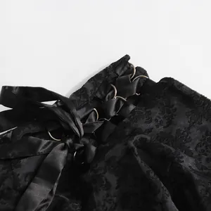Dettaglio della vita a corsetto stringata su una gonna lunga in pizzo jacquard nero