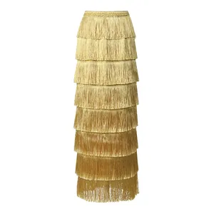 Detailed macro view of elegant layered golden tassels on a high-waist maxi skirt