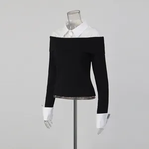 Close-up detail of fake two-piece black knit top with white shirt collar and cuffs
