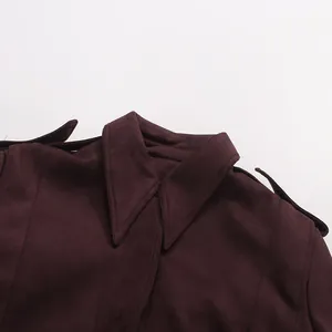 Detailed macro view showing the collar and shoulder texture of a maroon suede French jacket