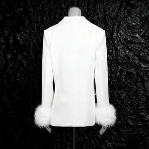Back view of elegant white blazer with luxurious faux fur cuffs and structured shoulders.