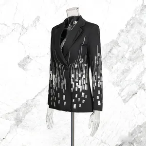 Detailed view of women's black blazer featuring shimmering silver sequin geometric design