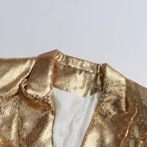 Close-up detail of a glamorous golden sequin blazer collar showing fine glitter texture