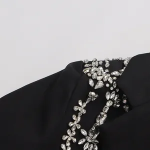 Detailed macro shot of luxury silver crystal floral patterns on a black designer blazer