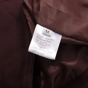 Close-up of garment care label showing 92% polyester and 8% spandex fabric composition