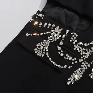 Detail shot of heavy industry black blazer featuring intricate rhinestone floral embellishments