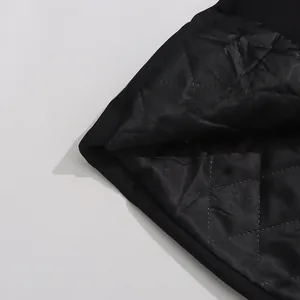 Close-up detail of the black diamond-quilted inner lining of a high-end luxury suit jacket