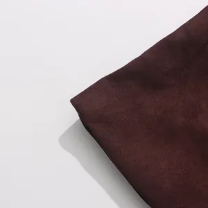 Macro detail showing the soft burgundy suede fabric texture of this elegant autumn trench coat