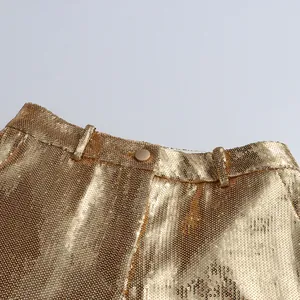 Close-up of the high-waist band on these gold sequined trousers.