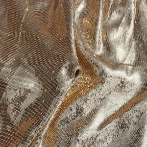Detail view of shimmering champagne gold sequin fabric for a luxury trendy pant suit