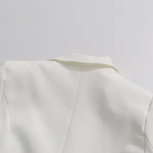 Detailed close-up view of elegant white blazer collar and high-quality shoulder stitching