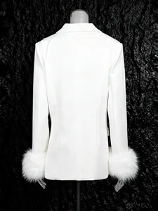 Elegant white blazer featuring luxurious faux fur cuffs for a high-end fashion look