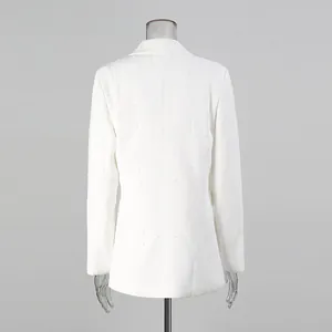 Back view detail of a white loose blazer with elegant vertical pearl decorations.