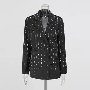 Detail of black blazer with elegant white pearl embellishments and relaxed fit design