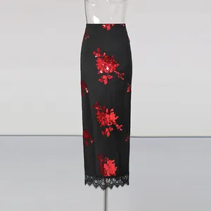Detail of high-waisted black skirt with red sequin flowers and lace hemline decoration