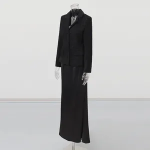High-end black tweed blazer and long satin skirt set displayed on a clear mannequin