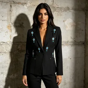 Detailed macro shot of a black women's blazer featuring elegant blue crystal teardrop accents