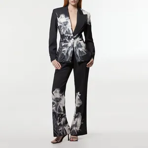 Elegant black two-piece suit with bold white floral print featuring wide-leg trousers
